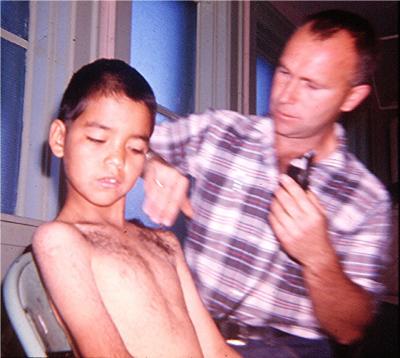 Photographs of boys getting haircuts