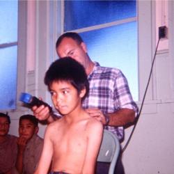 Photographs of boys getting haircuts