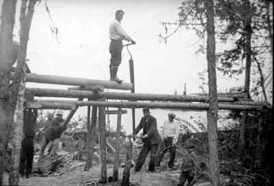 Photograph of men cutting wood at Fort Albany