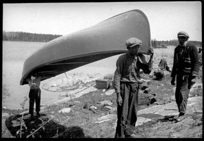 Photograph of three men with a canoe at Albany River