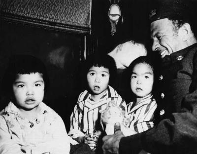 Photograph of students returning to school with a porter's assistance