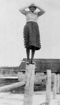 Photograph of Carrie Fletcher standing on a fence post