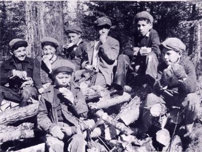 Photograph of students having a snack break in the woods