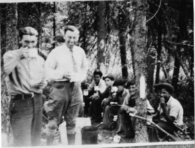 Photograph of students and staff picinicing in the woods