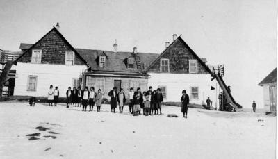 Photograph of students in front of the old St. John's Residential School building