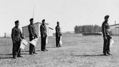 Photograph of five student cadets ready to perform a signalling drill