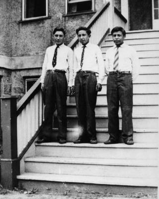 Photograph of John Langie, Lawrence Mashequis, and Bernard Smoke at graduation