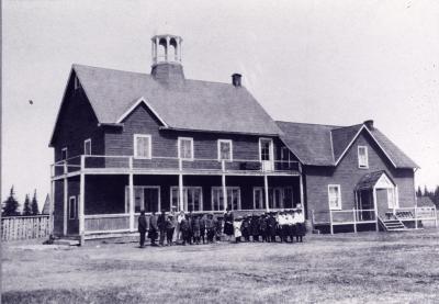 Photograph of students and staff in front of the old Bishop Horden Memorial Residential School building