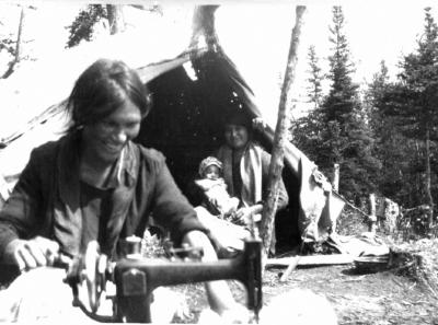 Photograph of a woman sewing outside