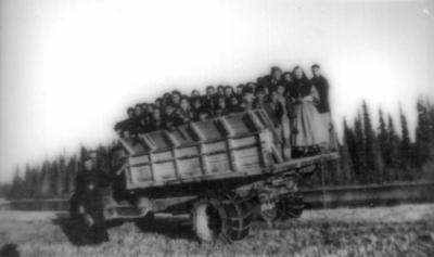 Photograph of students and staff on a wagon