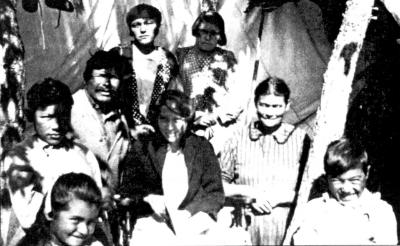 Photograph of group of women and children outside