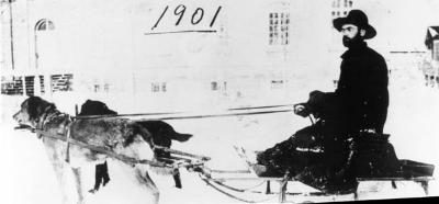 Photograph of a missionary on a dog sled at Wikwemikong