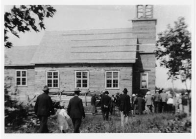 Photograph of a group of people entering a chapel in Batchawana
