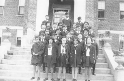 Photograph of students on the front steps of Shingwauk Hall