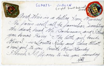 Photograph of students and teachers along a fence