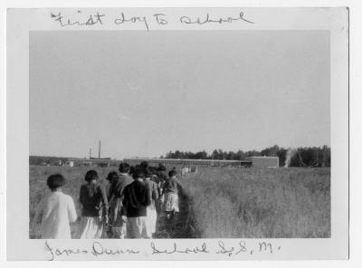 Photograph of students walking to James Dunn School on the first day of school